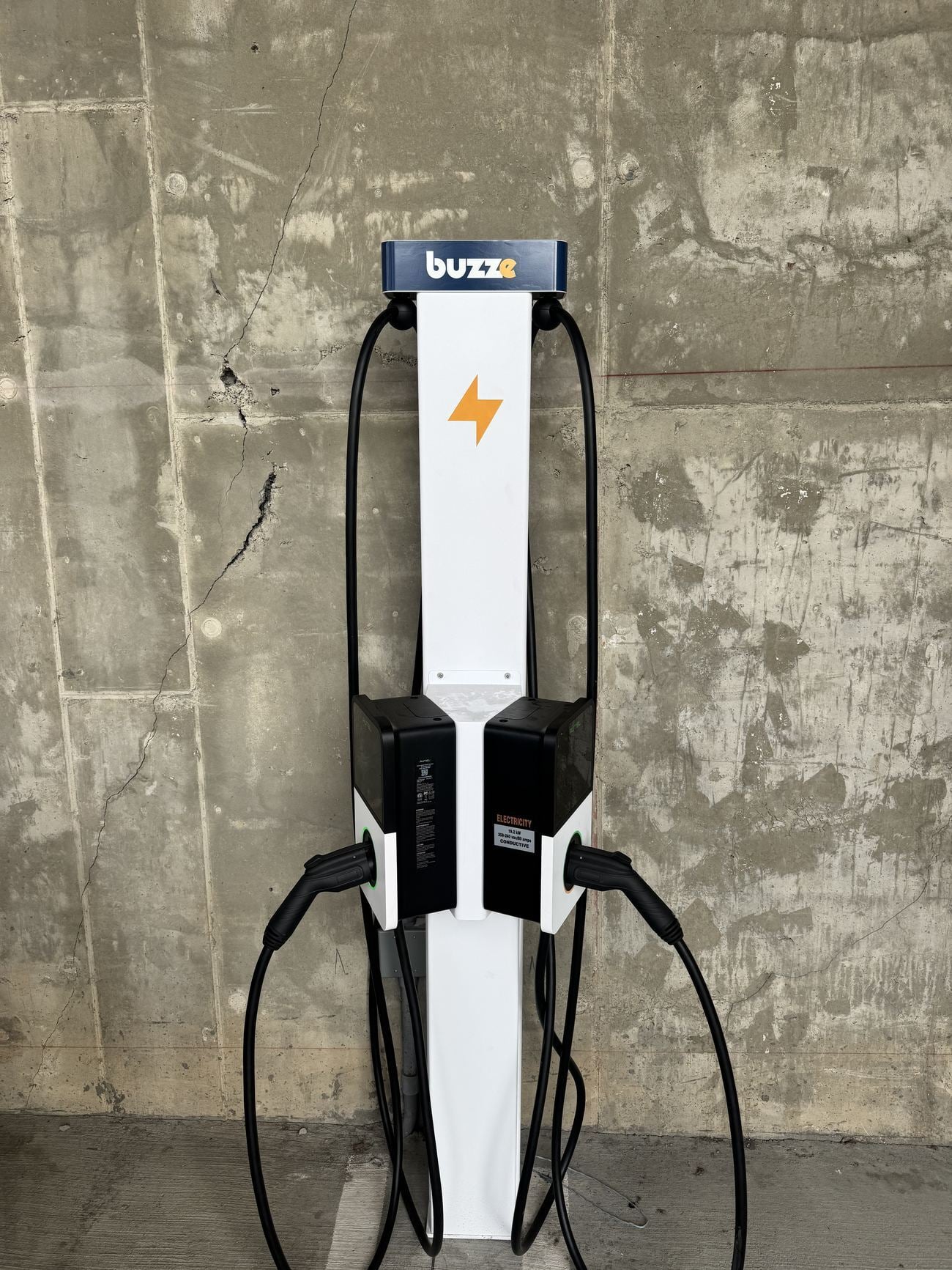 Dual chargers on a pedestal in a structured garage