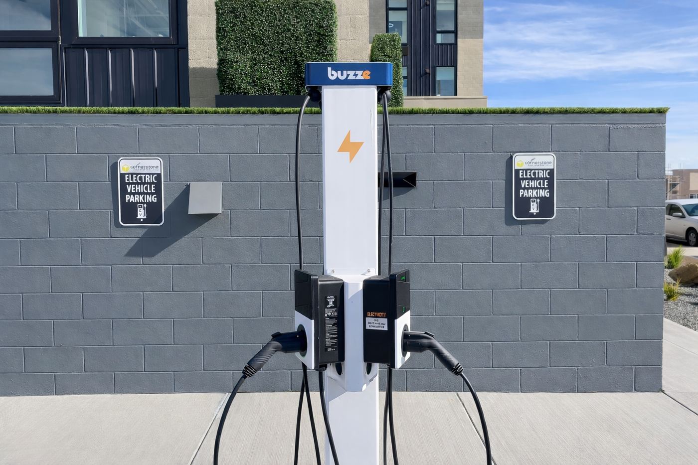Buzze branded pedestal with dual chargers and EV parking signage