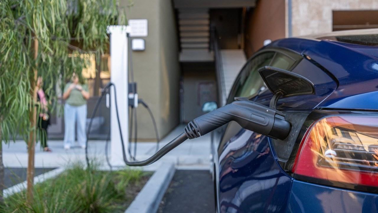 Resident plugging in at a Buzze charger